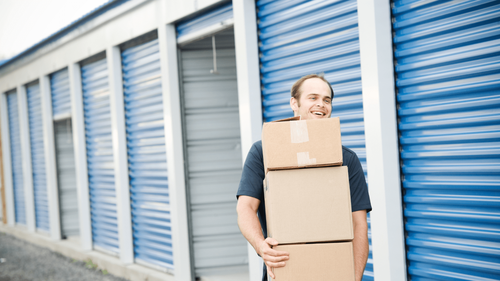 Man moving boxes out of a storage unit